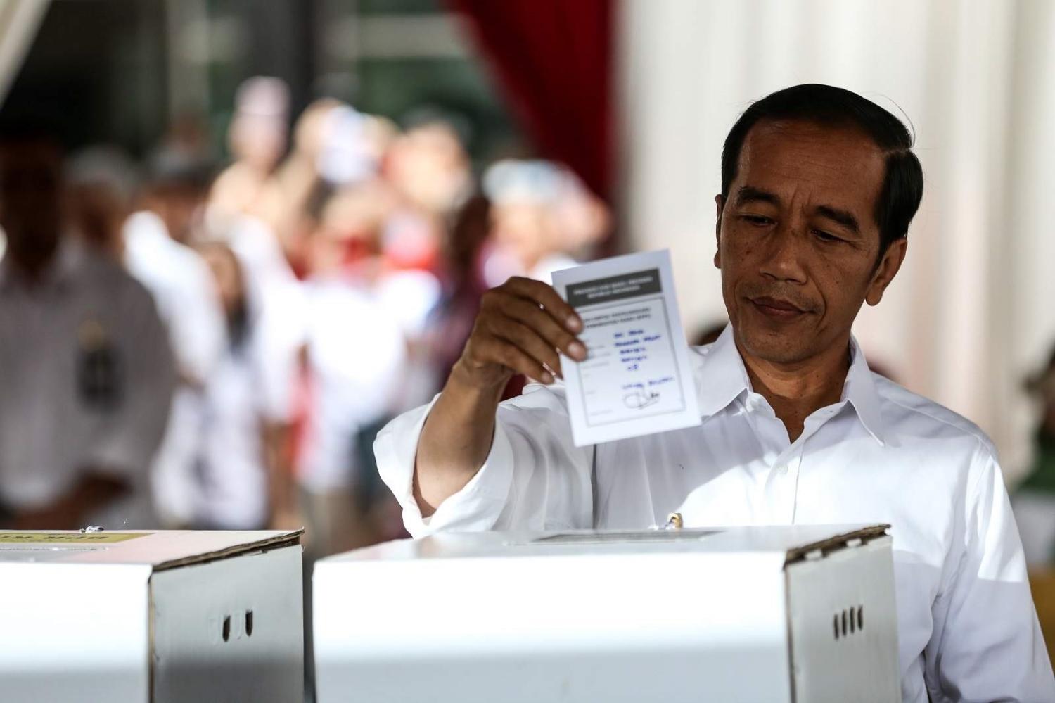 Indonesian President Joko Widodo votes during the 2019 election at a polling station in Jakarta, 17 April 2019 (Andrew Gal/NurPhoto via Getty Images)