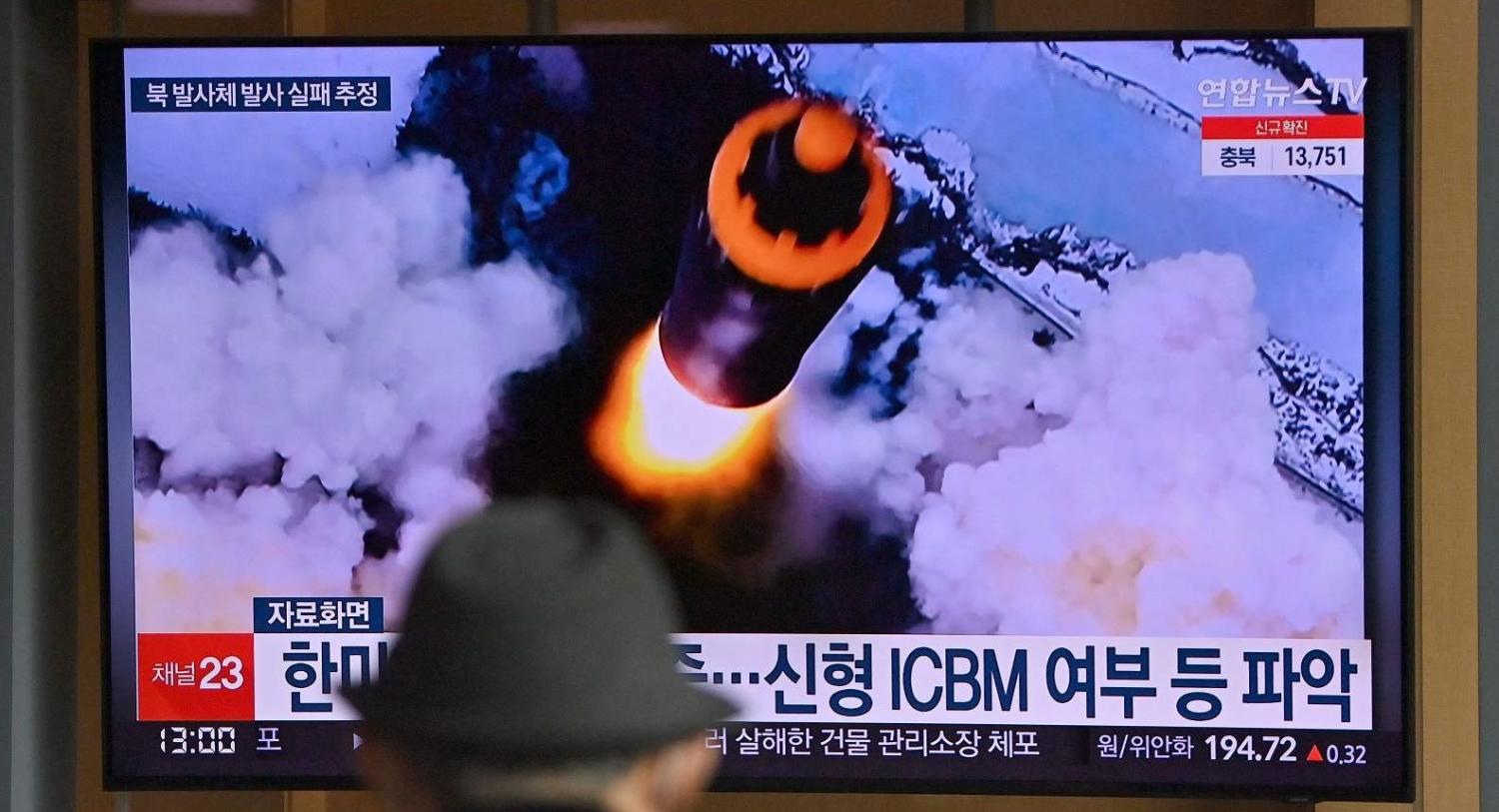 A news broadcast shows file footage of a North Korean missile test after North Korea fired an “unidentified projectile” on 16 March 2022 that appears to have immediately failed (Jung Yeon-Je/AFP via Getty Images)