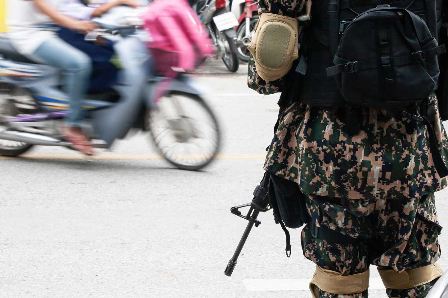 Royal Thai Army soldier on patrol near a local market at Narathiwat, during South Thailand's insurgency conflict (Tanes Ngamson/Getty Images)