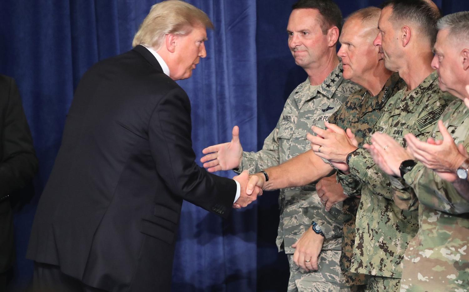 President Donald Trump greets military leaders before his speech on Afghanistan. (Photo by Mark Wilson/Getty Images)