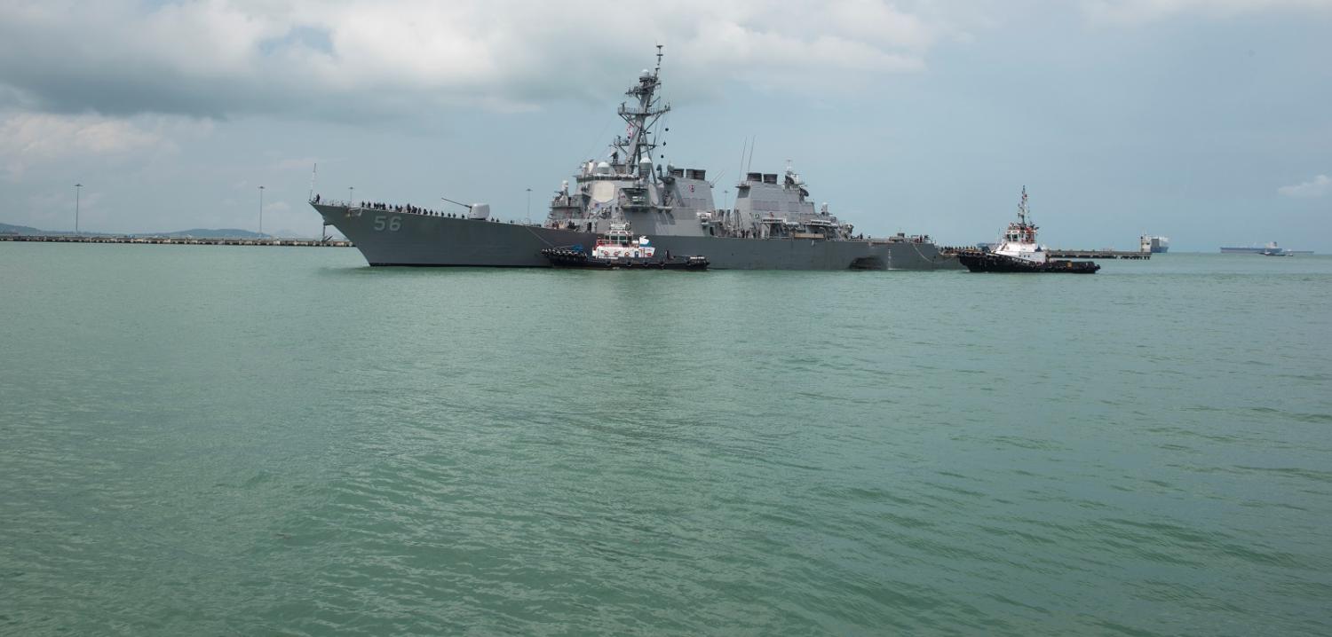 Tugboats assist the USS John S. McCain as it steers towards Changi Naval Base following the 21 August collision with a merchant vessel. (Photo: US Navy via Getty Images)