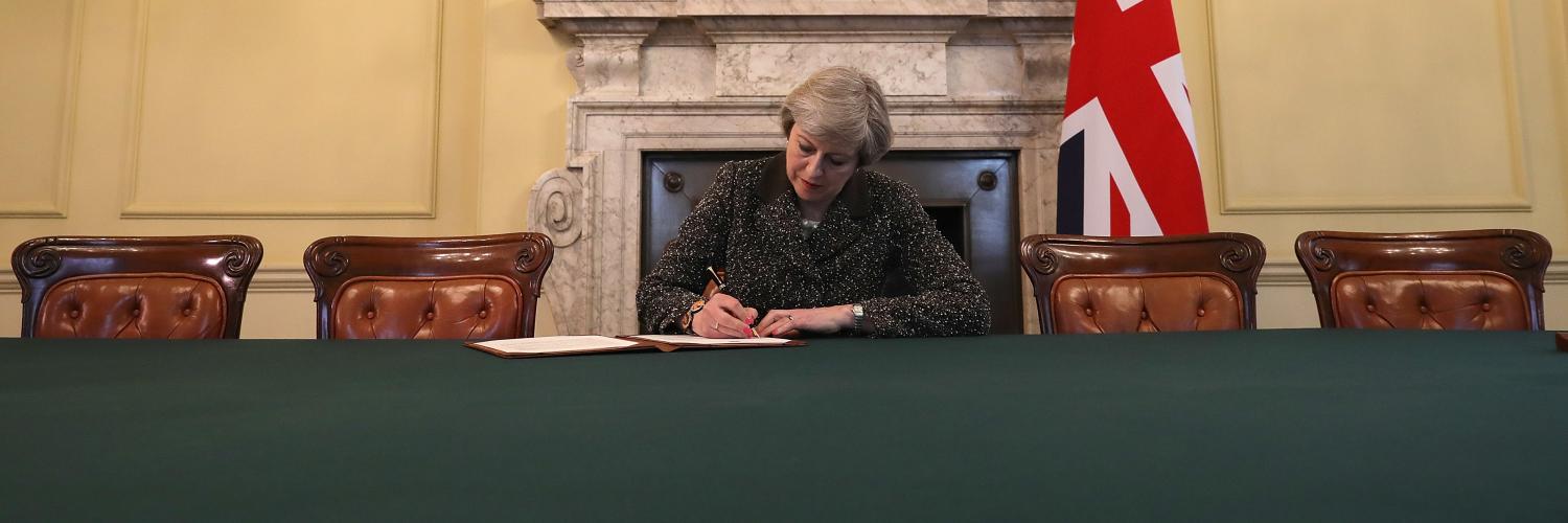 British Prime Minister Theresa May signing the letter to European Council President Donald Tusk invoking Article 50 (Photo: Getty Images/Christopher Furlong)