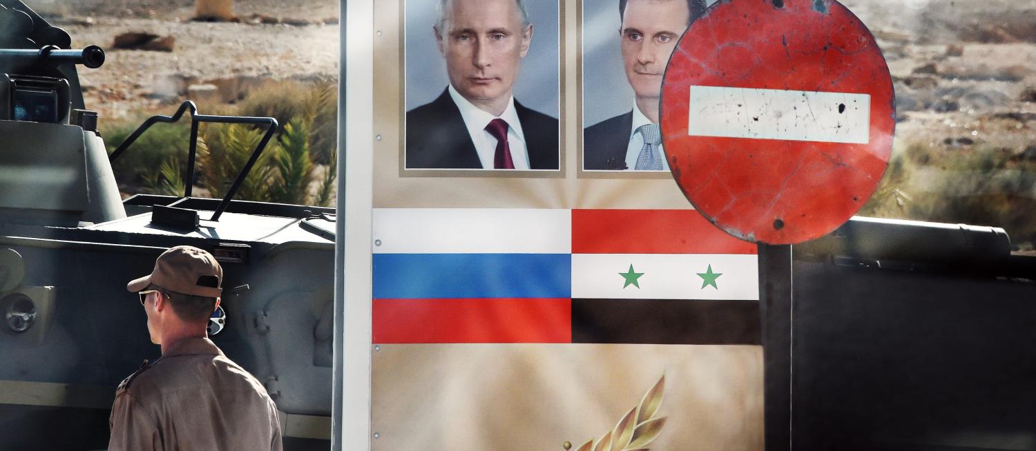 A sign featuring Russian President Vladimir Putin and Syrian President Bashar al-Assad in Palmyra, May 2016 (Photo: Getty Images/Kommersant Photo)