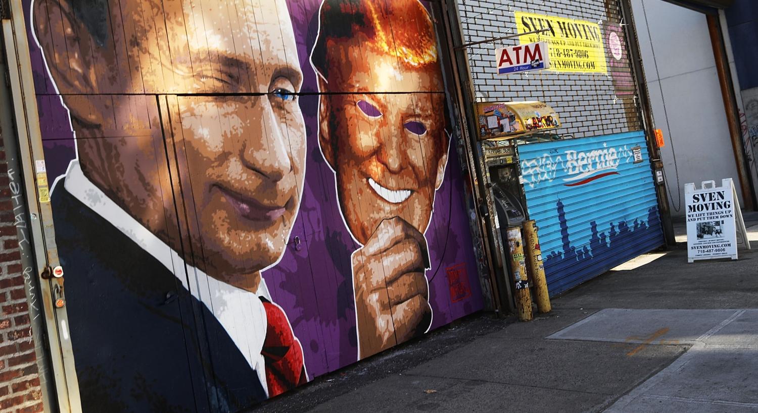 A mural depicting Vladimir Putin taking off a Donald Trump mask, New York, 2017 (Photo: Getty Images/Spencer Platt)