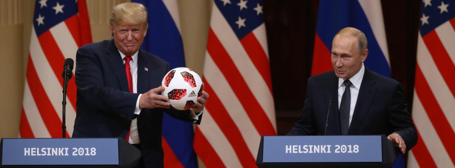 Russian President Vladimir Putin gives US President Donald Trump a football after their summit in Helsinki (Photo: Mikhail Svetlov/Getty)