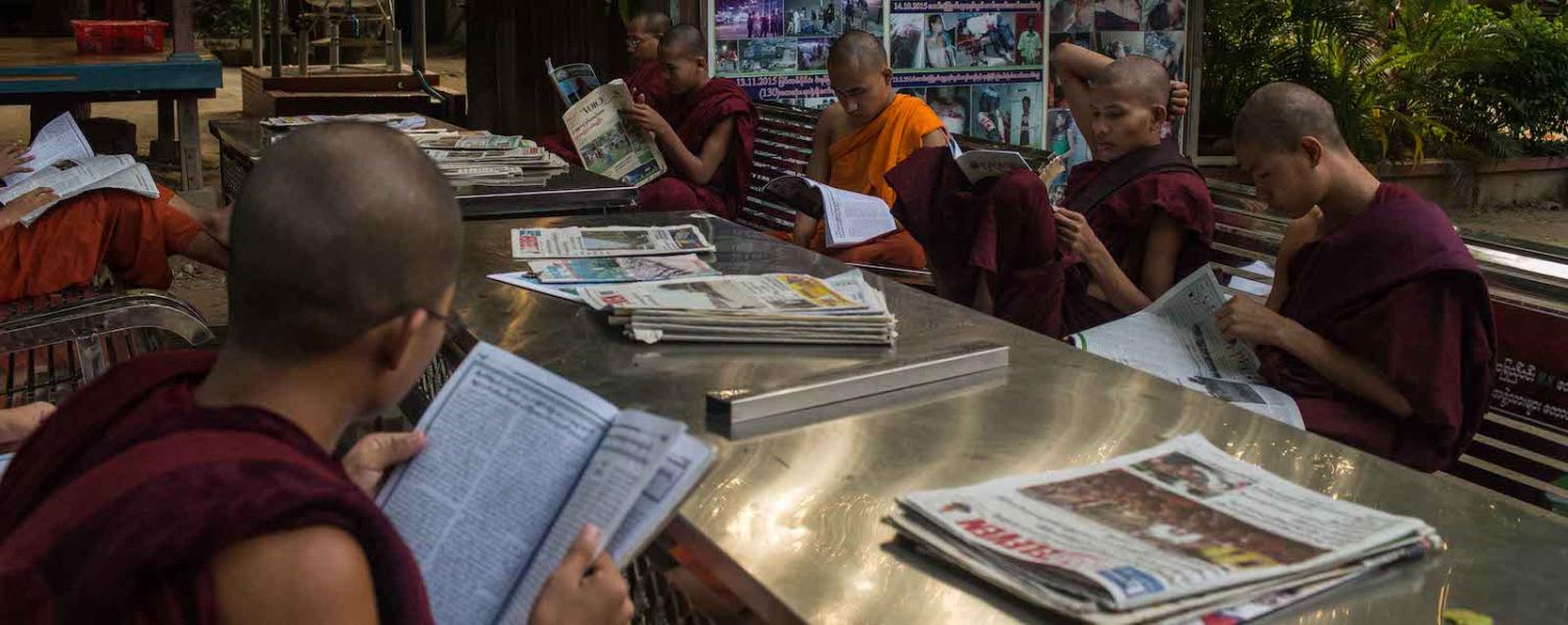 Monks at the Masoeyein Monastery read newspapers in Mandalay, (Photo: Lauren DeCicca/Getty)