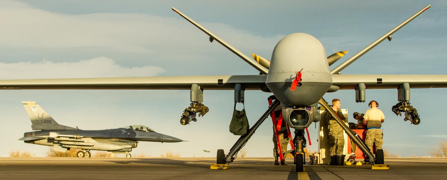 An MQ-9 Reaper with an F-16 in the background. (Airman Magazine/ Flickr)