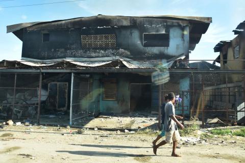 Burnt-out buildings in Honiara’s Chinatown on 27 November 2021 after days of intense rioting (Charley Piringi/AFP via Getty Images)
