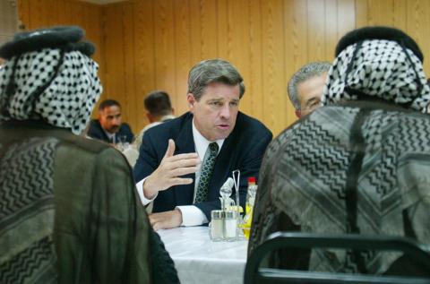 Paul Bremer (centre), as head of the Coalition Provisional Authority, speaking with local Iraqi leaders in Hillah, Iraq, June 2003 (Bullit Marquez/AFP via Getty Images)