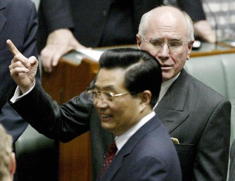 Then Chinese President Hu Jintao (L) with Australian PM John Howard at the Australian Parliament during a joint sitting of both houses in Canberra, 24 October 2003 (AFP via Getty Images)