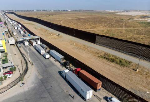 Trucks queue to cross the border into the US at the Otay commercial crossing point in Tijuana, Mexico, 7 July 2020 (Guillermo Arias/AFP via Getty Images)