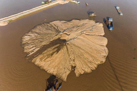 Land reclamation on the Mekong in Cambodia, one of a number of practices robbing topsoil in regions downstream (Andrew Maurice Ball via Getty Images)