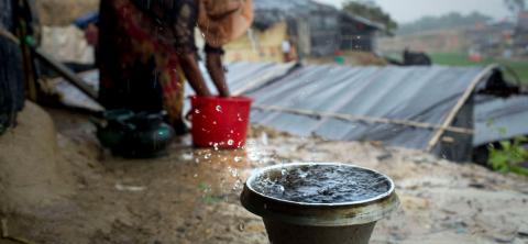  A Rohingya refugee collects drinking water in heavy rain at Ukhiya, Cox's Bazar (Photo by K M Asad/Getty)