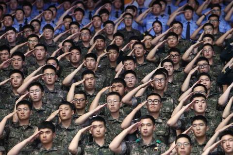 South Korean soldiers salute during a ceremony to mark the anniversary of the Korean War, 25 June (Photo: Chung Sung-Jun/Getty)