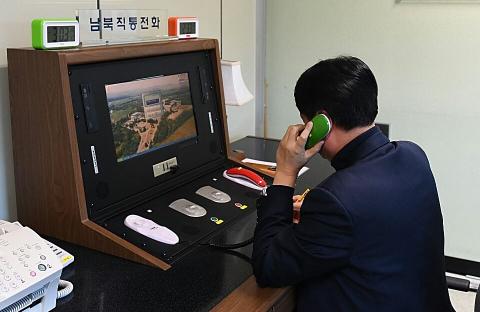 A South Korean official checks the direct communications hotline to talk with the North Korean side in 2018. After a period of radio silence, the hotline reportedly reopened again in late July 2021 (South Korean Unification Ministry/Getty Images)